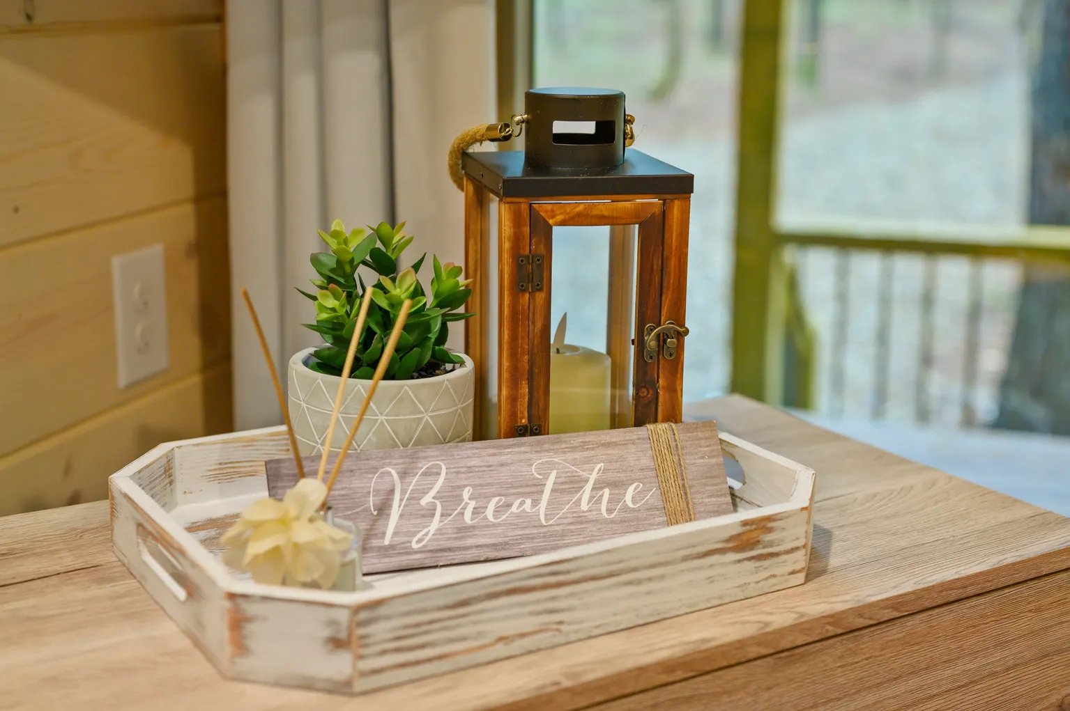 Lantern and Breathe sign on deck table