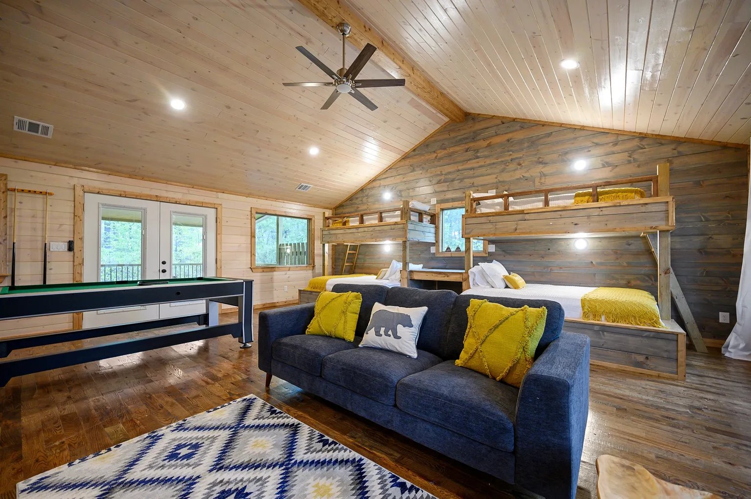Bunk room with two sets of twin over queen bunks