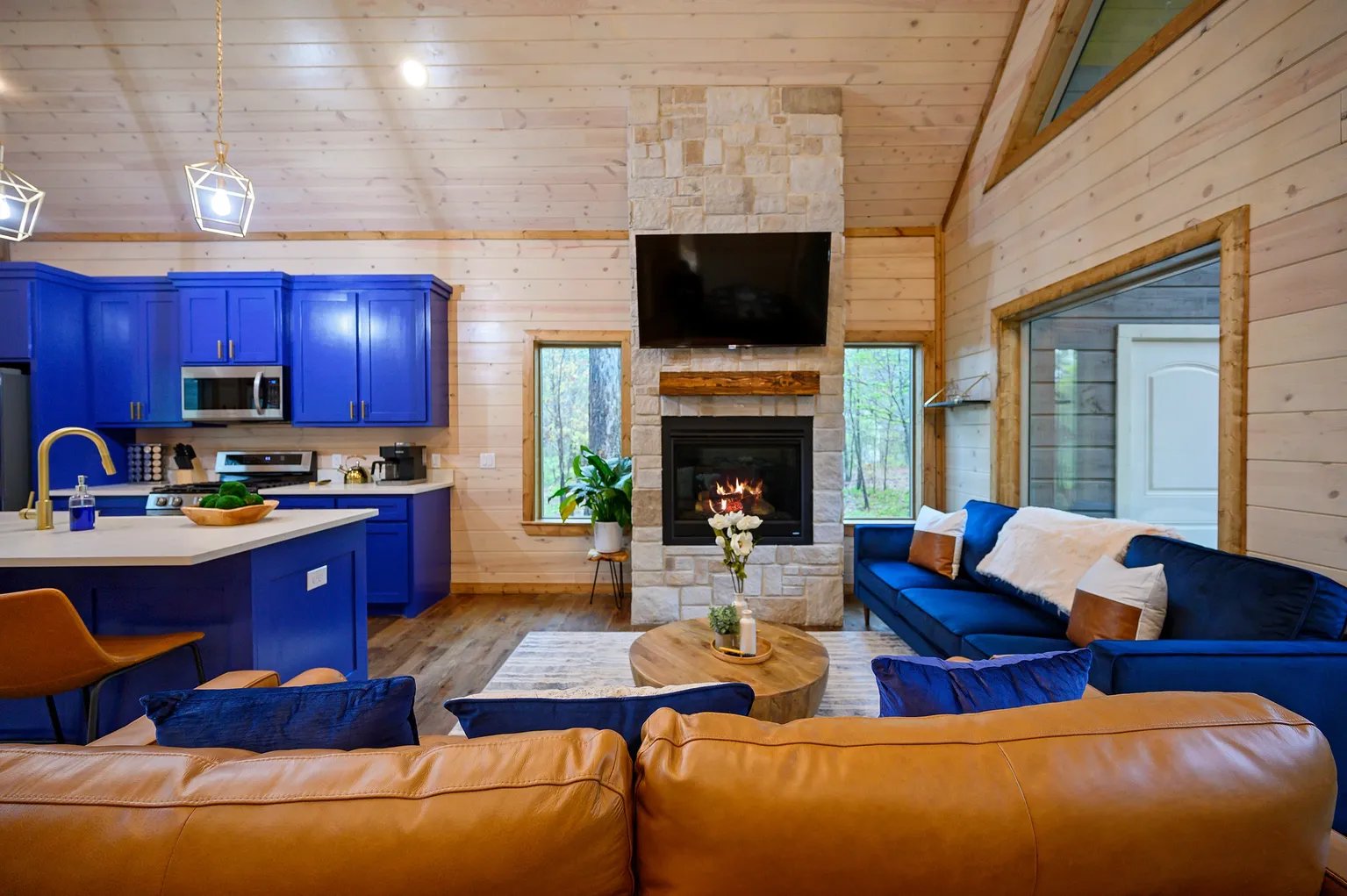 Living room with blue cabinets and stone fireplace